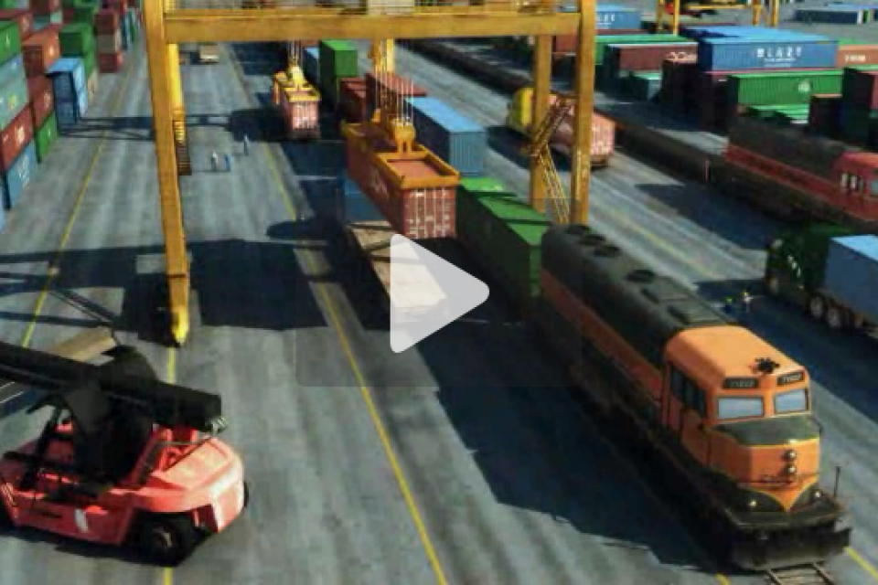 Cargo train and containers at shipping yard, with crane and vehicle nearby.