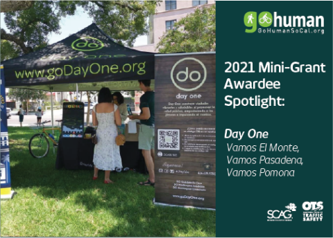 Day One booth at outdoor event with tent and informational signs.